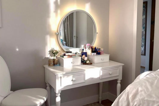 Meuble blanc avec miroir lumineux et accessoires de maquillage